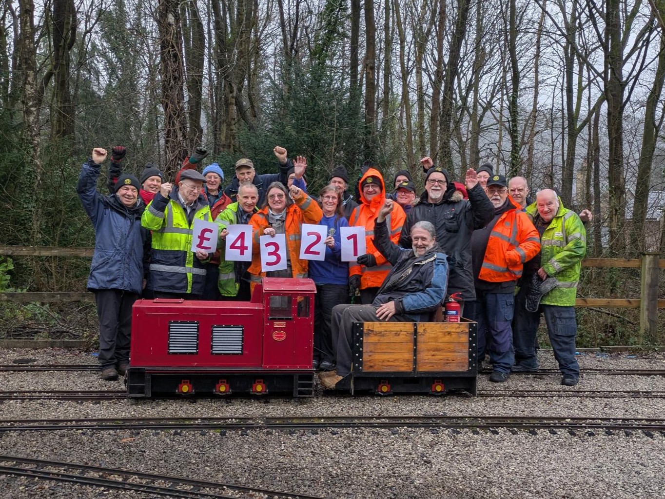Abbeydale Miniature Railway team pictured on their railway with their £4321 fundraising numbers for St Luke's Hospice.
